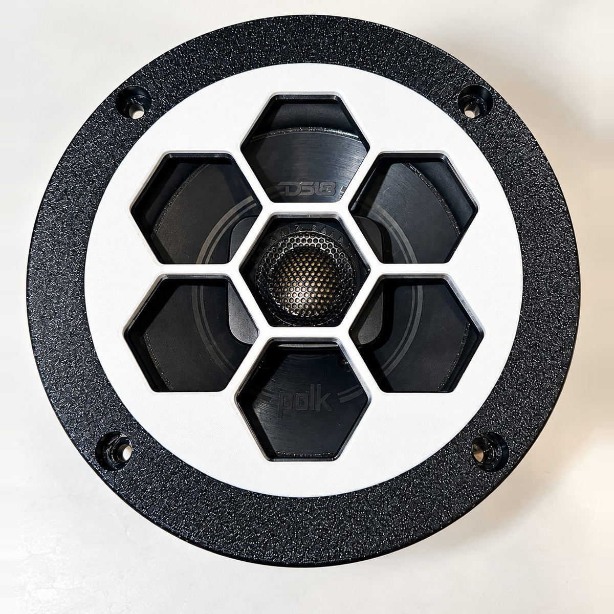 Polk DB522 5.25 hex grill installed on a speaker, center hex over the tweeter