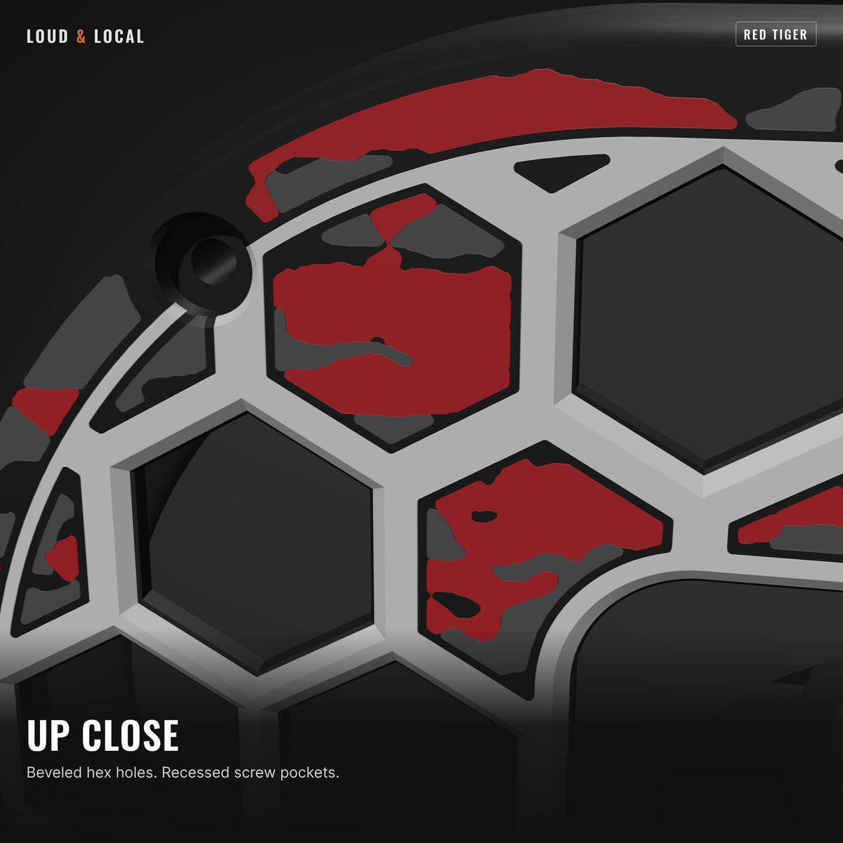 Close-up of the Red Tiger camo grill showing beveled hex holes and a recessed screw pocket